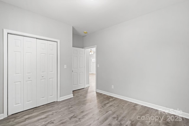 unfurnished bedroom with light hardwood / wood-style flooring and a closet