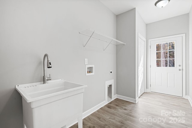 washroom featuring hookup for an electric dryer, hookup for a washing machine, light wood-type flooring, and sink