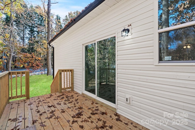 wooden deck with a lawn