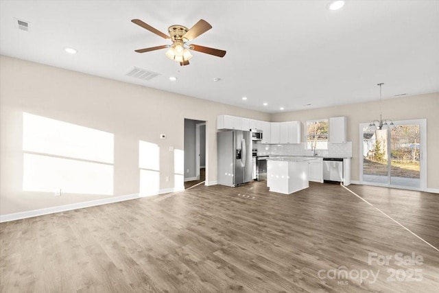 unfurnished living room featuring ceiling fan, dark hardwood / wood-style flooring, and sink