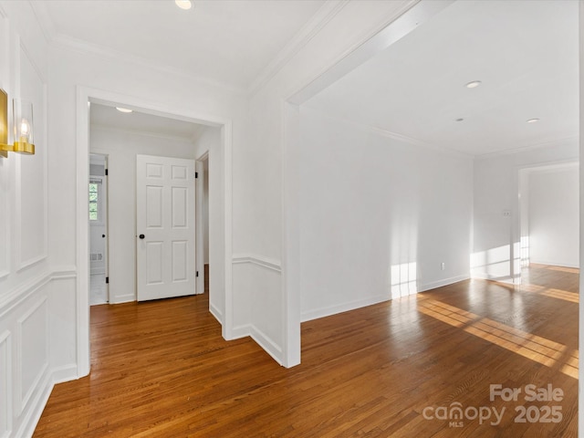 interior space featuring wood-type flooring and ornamental molding