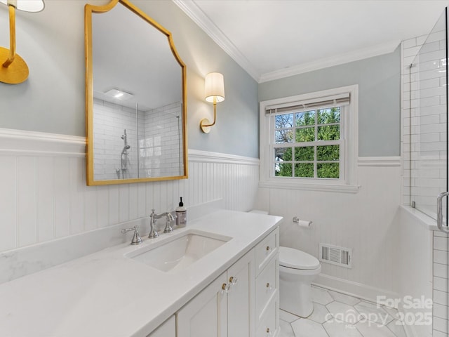 bathroom featuring ornamental molding, vanity, tile patterned flooring, toilet, and a shower with shower door