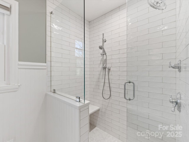 bathroom with a shower with door