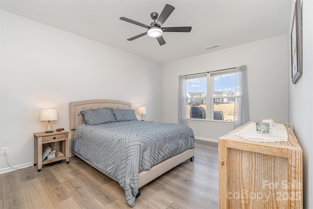 bedroom with wood-type flooring and ceiling fan