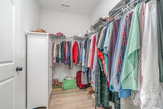 spacious closet with light hardwood / wood-style flooring