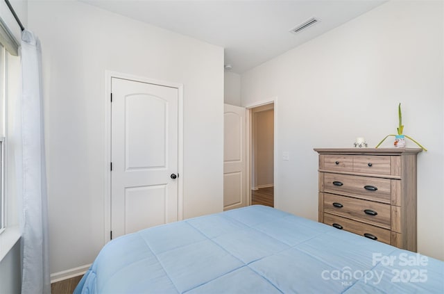 bedroom with dark hardwood / wood-style floors