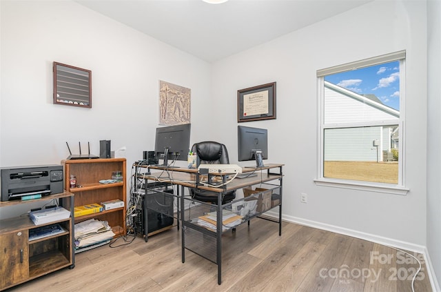 office space with light wood-type flooring