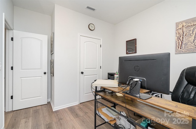 office with light hardwood / wood-style flooring