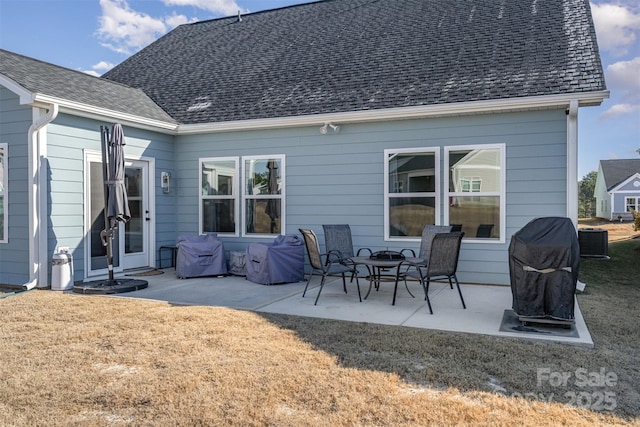 rear view of house with a yard, a patio, and central AC unit