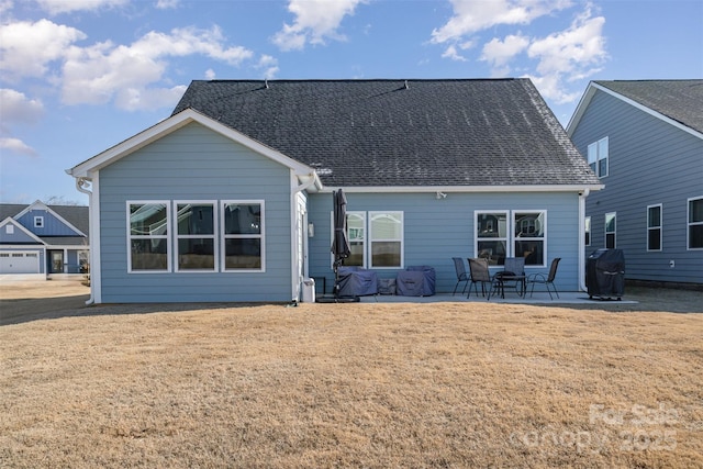 back of property featuring a lawn and a patio area