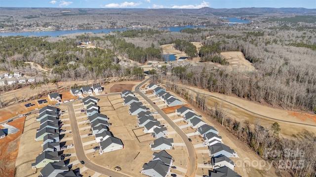 birds eye view of property with a water and mountain view