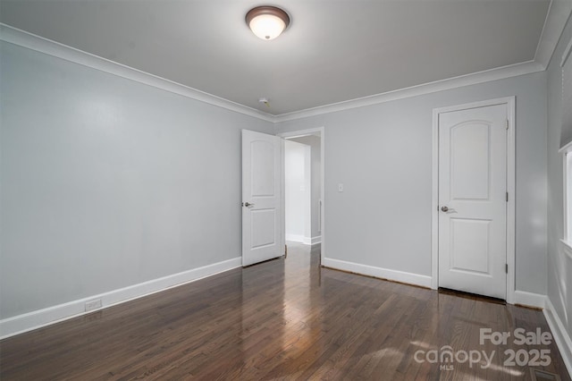 unfurnished room featuring crown molding and dark hardwood / wood-style floors