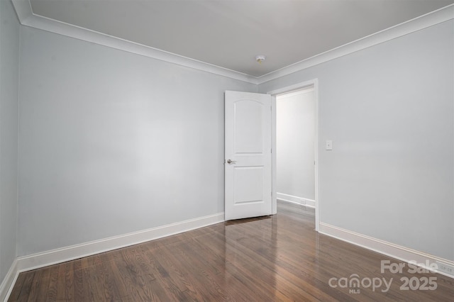 unfurnished room with dark wood-type flooring and crown molding