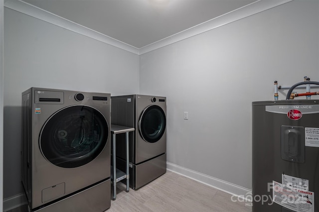 washroom with crown molding, water heater, and washing machine and clothes dryer