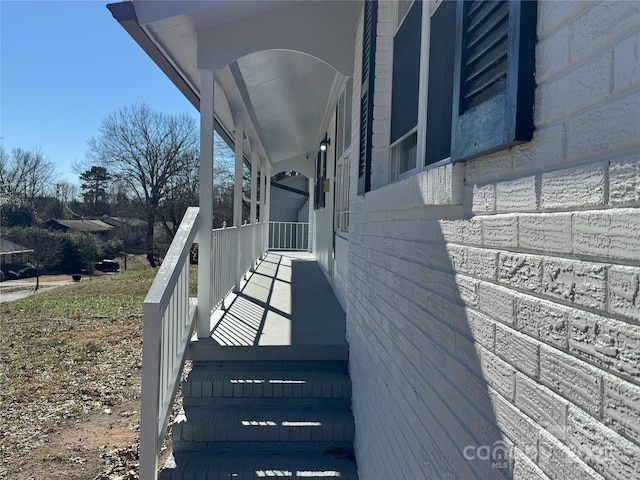 view of side of home with covered porch