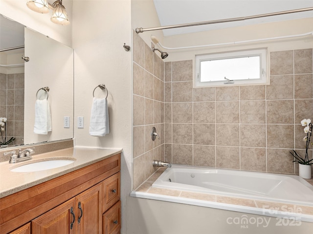 bathroom with tiled shower / bath combo and vanity