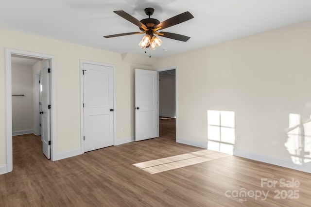 unfurnished bedroom with wood finished floors and baseboards