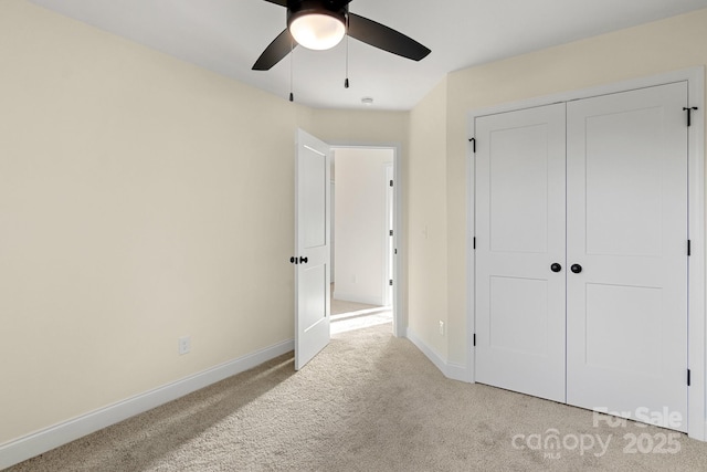 carpeted bedroom with ceiling fan, a closet, and baseboards