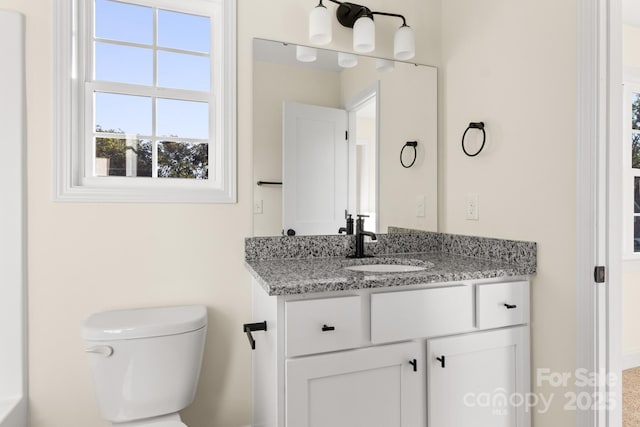 bathroom featuring toilet and vanity