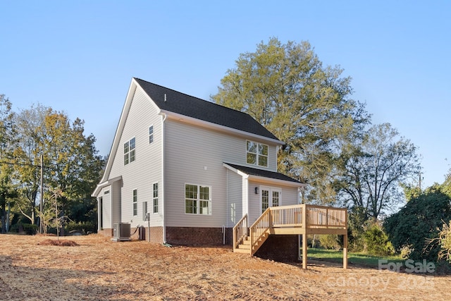 exterior space with central AC, a wooden deck, and stairs