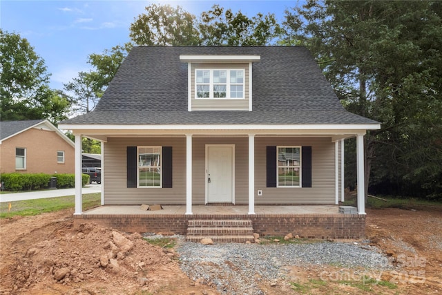 bungalow with a shingled roof and a porch