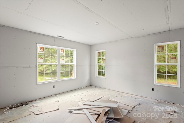 unfurnished room featuring visible vents