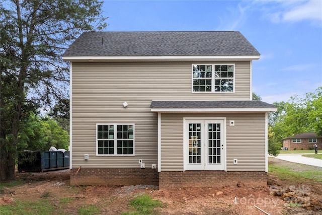 rear view of property featuring roof with shingles