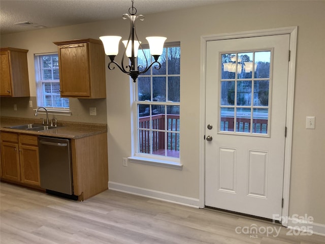 doorway to outside featuring light hardwood / wood-style floors, sink, a textured ceiling, and a chandelier