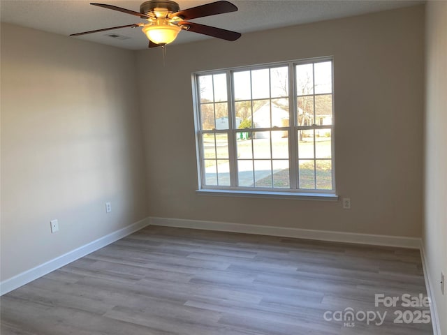 unfurnished room with ceiling fan and light hardwood / wood-style floors