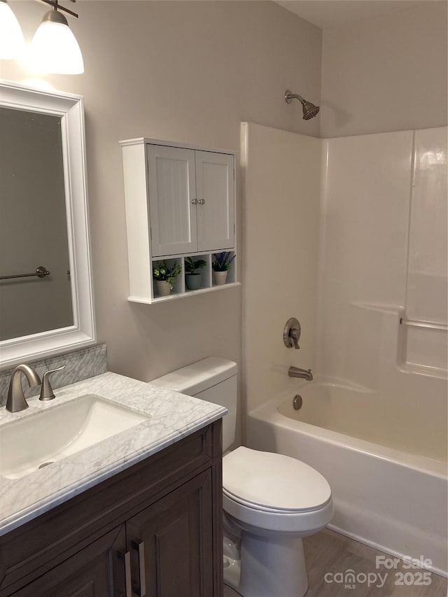 full bathroom featuring toilet, vanity, and shower / washtub combination