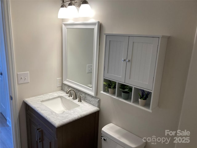 bathroom featuring toilet and vanity