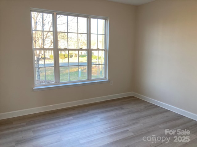 unfurnished room with hardwood / wood-style flooring