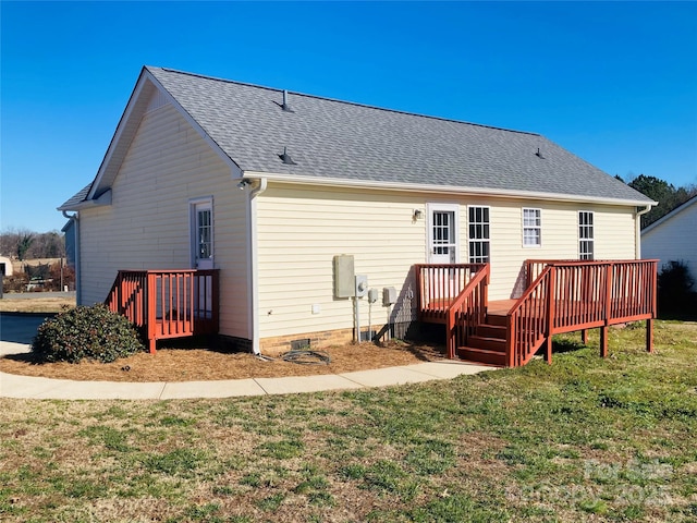 back of property featuring a deck and a yard