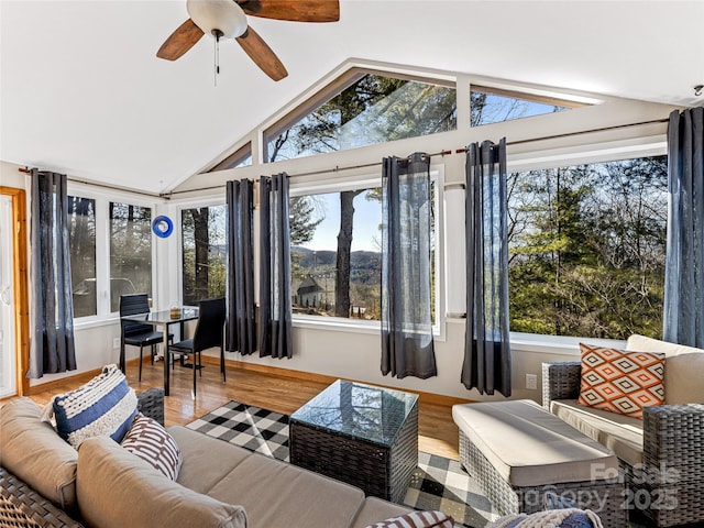 sunroom / solarium with lofted ceiling, a wealth of natural light, and ceiling fan