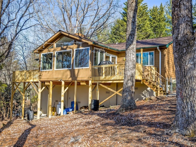 back of house featuring a wooden deck