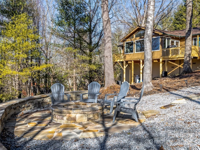 view of patio featuring a wooden deck and an outdoor fire pit