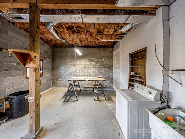 basement featuring sink and washer / dryer