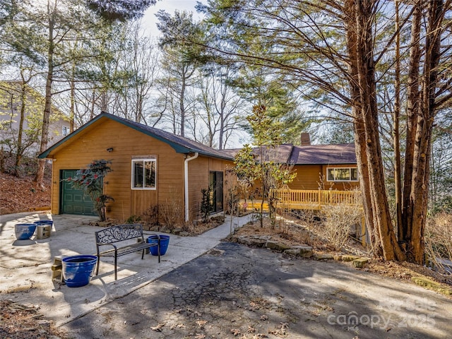 rear view of property featuring a garage