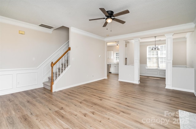 unfurnished living room with light wood-type flooring, stairs, visible vents, and a textured ceiling