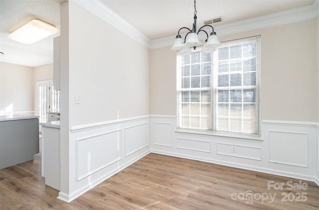 unfurnished dining area featuring a wealth of natural light, light wood finished floors, and visible vents