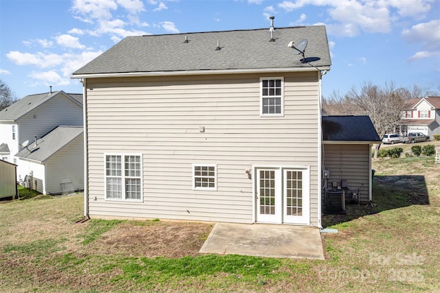 back of house with a patio, a yard, and a shingled roof