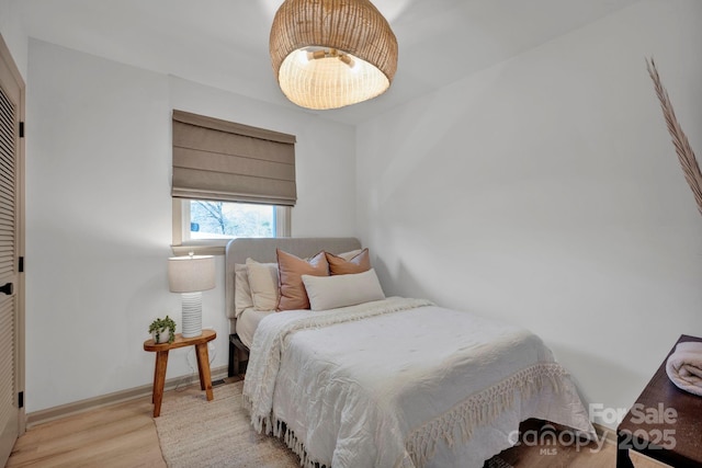 bedroom with light wood-type flooring and a closet