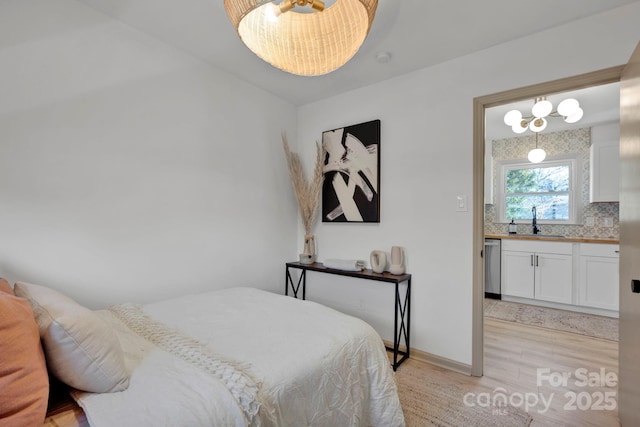 bedroom featuring sink and light hardwood / wood-style floors