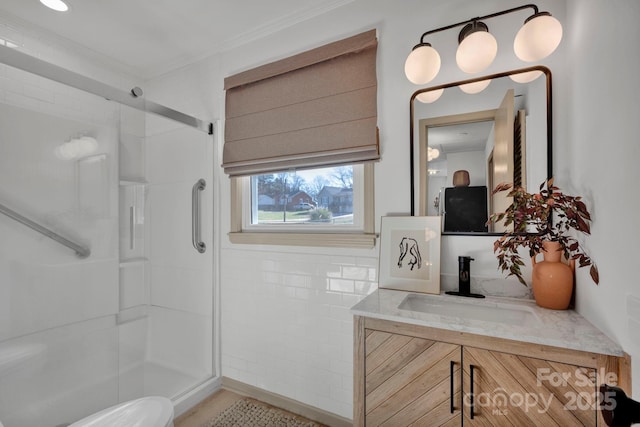 bathroom with vanity and a shower with door