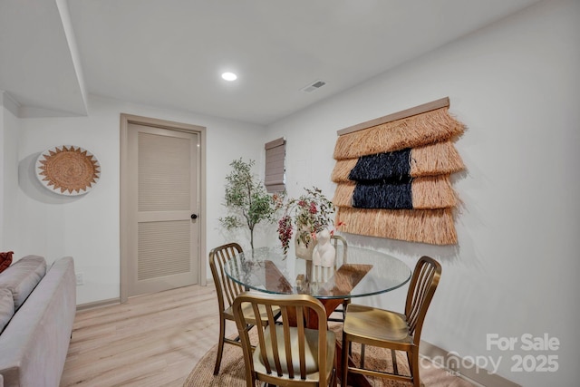 dining area featuring light wood-type flooring