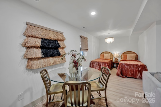 dining space with an inviting chandelier and light wood-type flooring