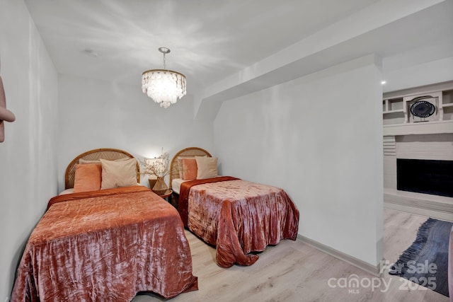 bedroom featuring a notable chandelier and light hardwood / wood-style flooring