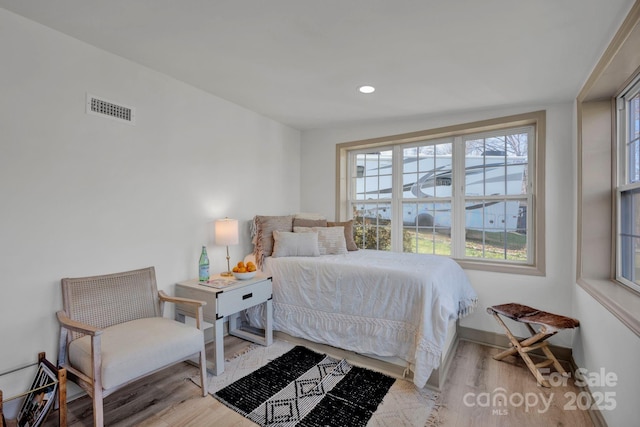 bedroom with light hardwood / wood-style flooring and vaulted ceiling