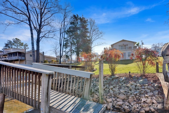 wooden deck with a lawn