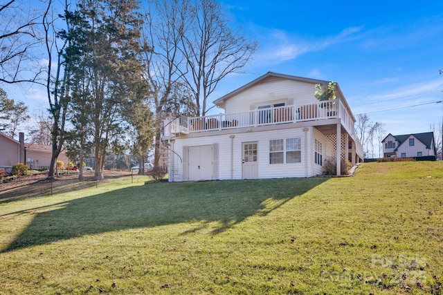 rear view of house featuring a balcony and a lawn